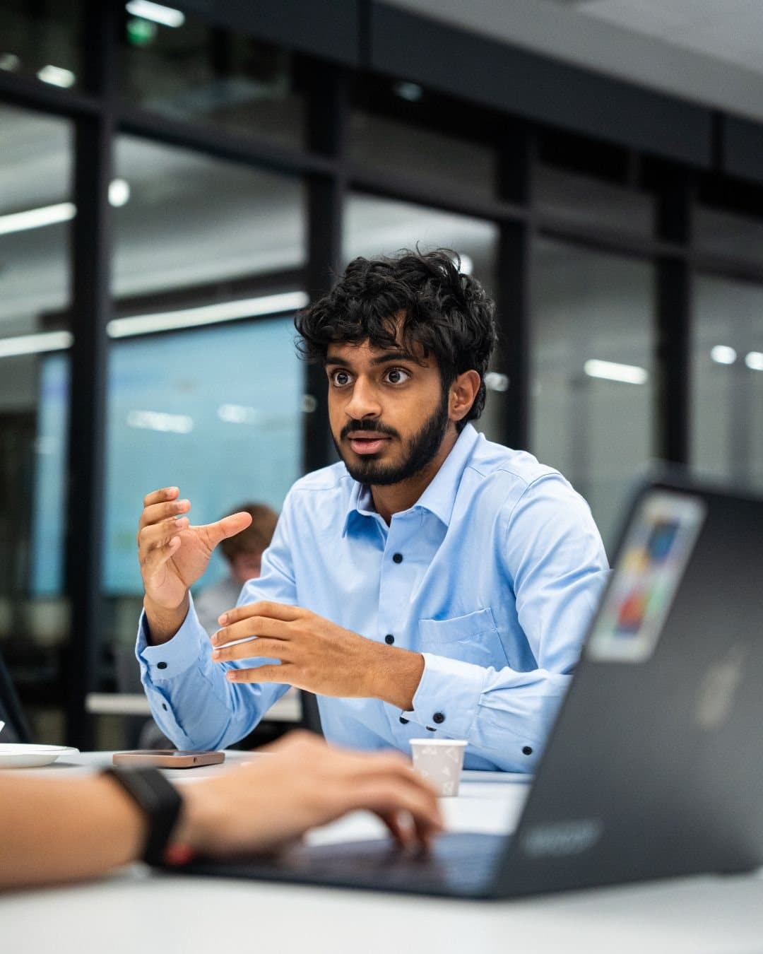 Limitless members listening during a founder-focused meeting.